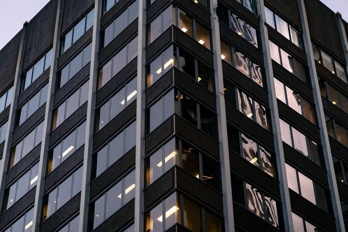 A modern office building against an evening sky